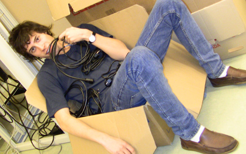 A lazy student lying in a cardboard box